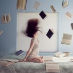 woman sitting on bed with flying books Strategies to Kick start Your Week as a Student
