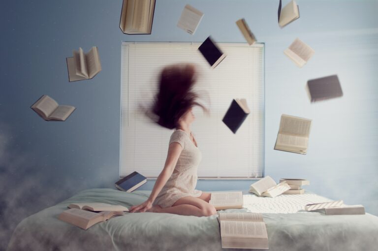 woman sitting on bed with flying books Strategies to Kick start Your Week as a Student